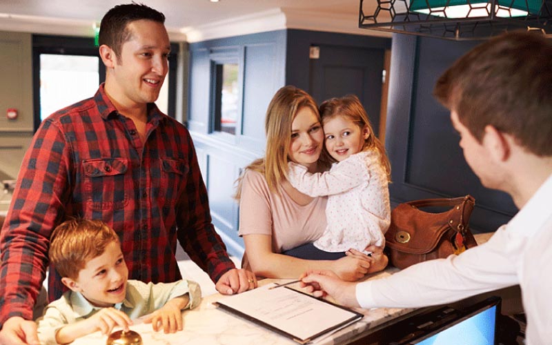 man checking in a boutique hotel with his family, Australian road trip, September 2024, Australia